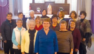 Kathy Herfel (front) and her fellow PCCW members gather in from of the altar at Sacred Heart Parish, Mondovi