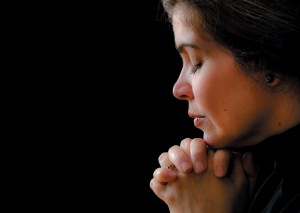 Hispanic woman praying to his saviour in heaven The Power of Prayer